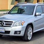 Side profile of the silver 2012 Mercedes Benz GLK 350, showcasing its pristine condition and classic SUV silhouette