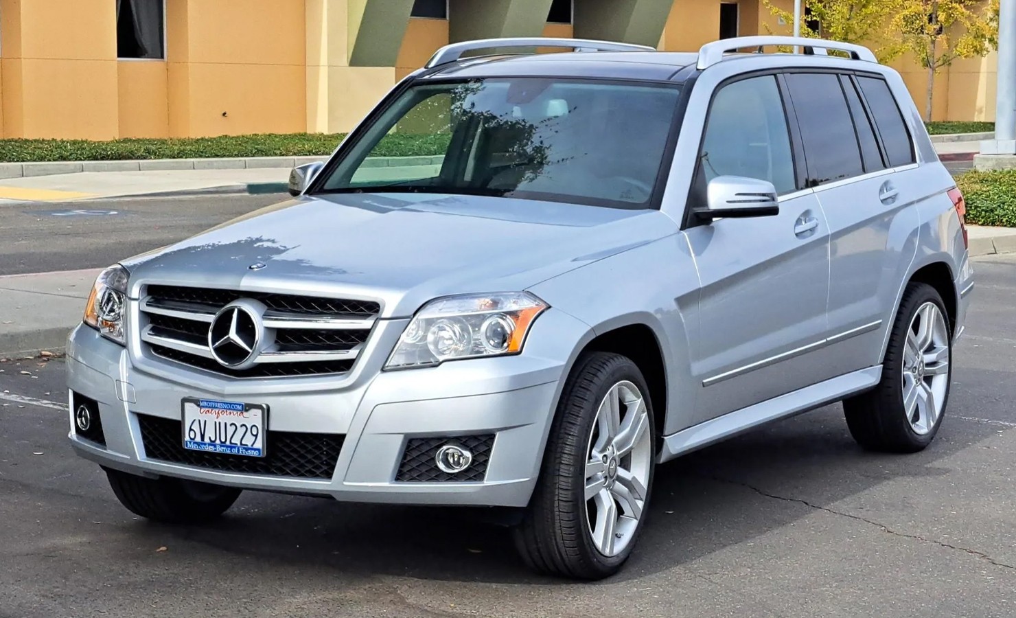 Side profile of the silver 2012 Mercedes Benz GLK 350, showcasing its pristine condition and classic SUV silhouette