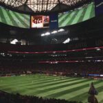 Inside the Mercedes-Benz Stadium overlooking the field ready for a game, showcasing the venue's impressive architecture.