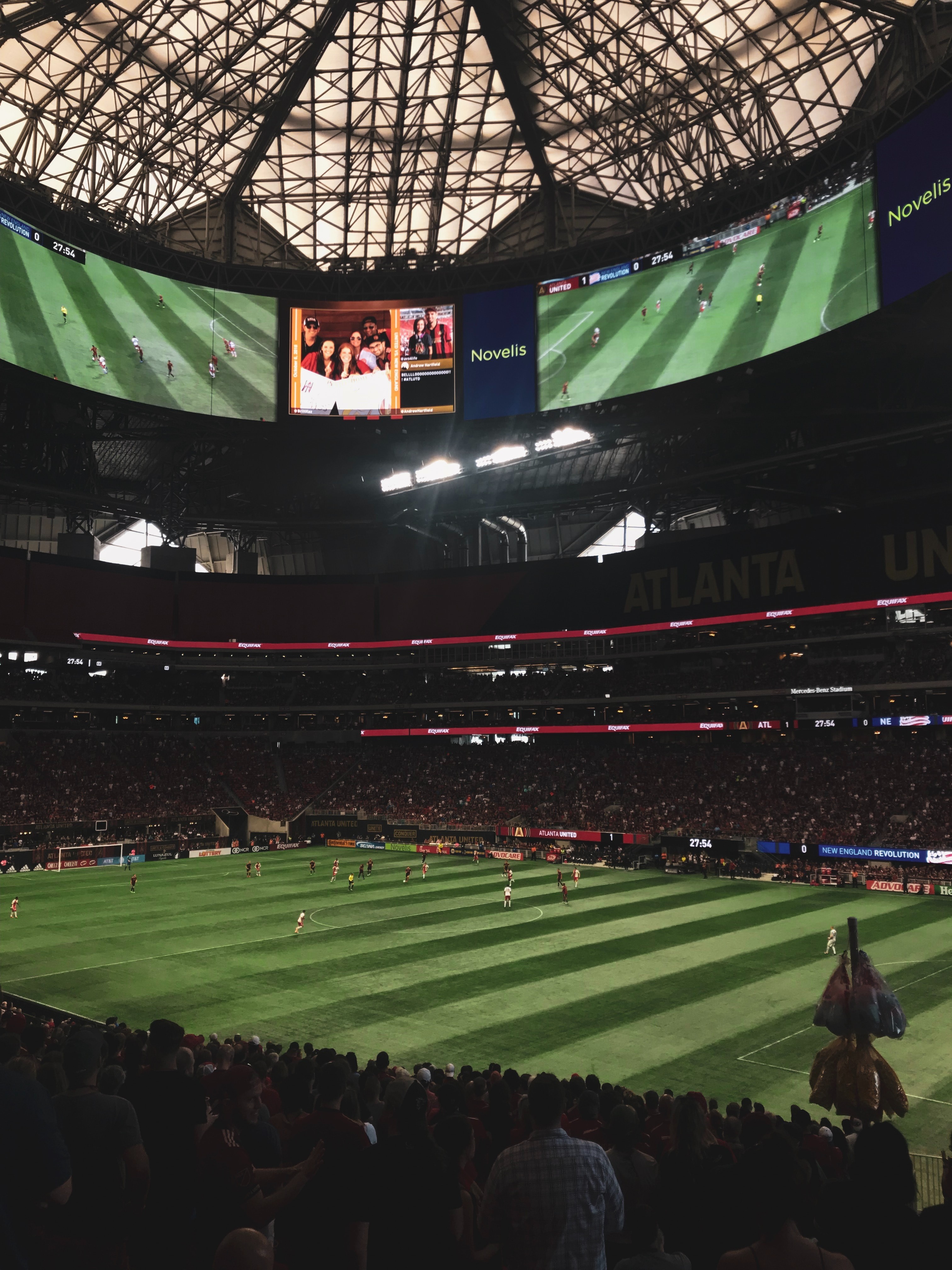 Inside the Mercedes-Benz Stadium overlooking the field ready for a game, showcasing the venue's impressive architecture.