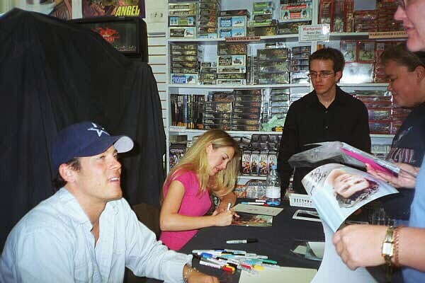 Mercedes McNab at an autograph session, smiling and engaging with fans