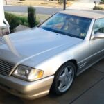 Liam Sullivan leaning on his 1999 Mercedes SL500