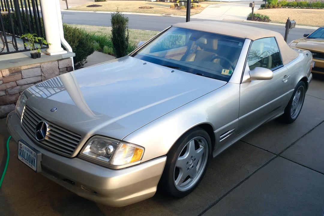 Liam Sullivan leaning on his 1999 Mercedes SL500