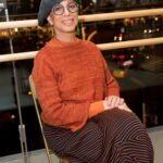 Mercedes Ellington smiling in a folding chair at Juilliard, showcasing her enduring connection to the prestigious performing arts school.